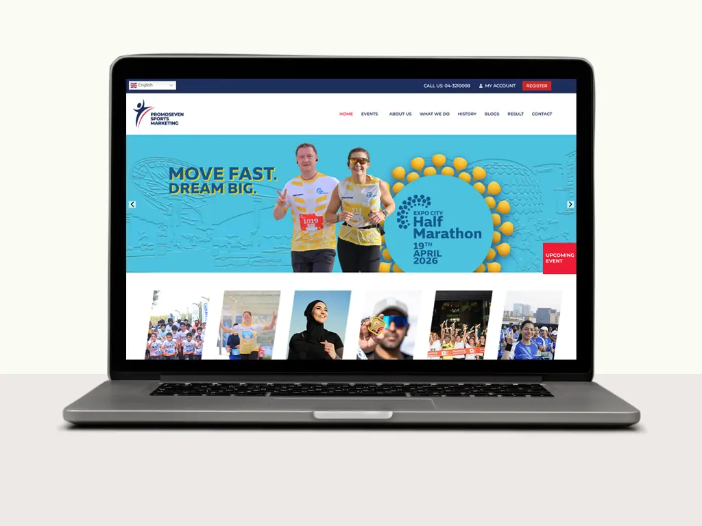 A laptop displays a colorful website promoting the Expo City Half Marathon, highlighting race details and upcoming events.