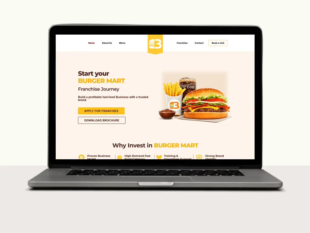 Laptop displaying a Burger Mart franchise webpage with promotional images of burgers, fries, and a drink, and calls to action for applications.